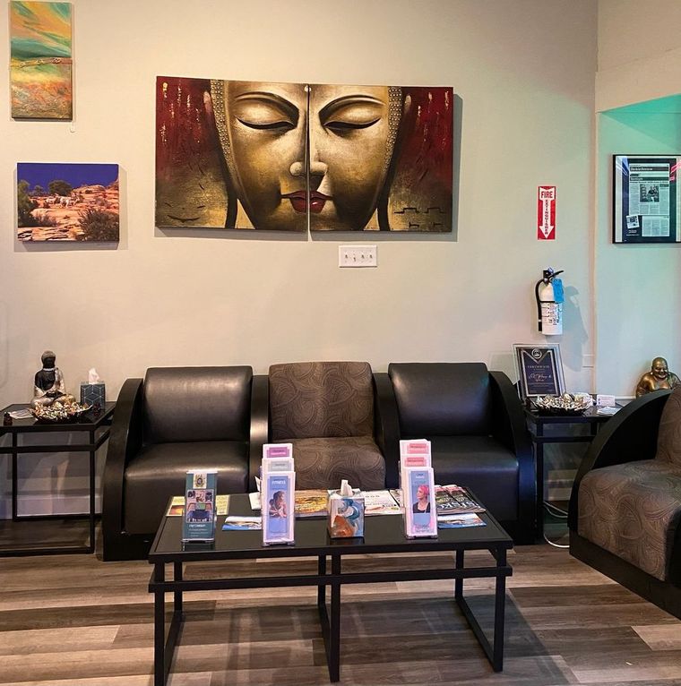 The VRC lobby: leather armchairs, a low table of brochures, and a large gold Buddha painting on the wall.